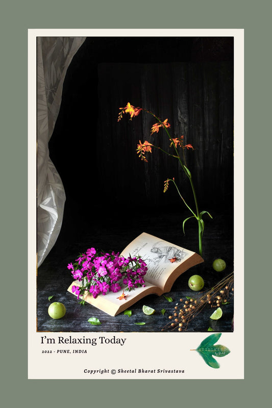 I'm Relaxing Today (2022) - Magenta phlox on open antique book with orange crocosmia, green limes and dried seed heads, fine art print by Stillness by Sheetal