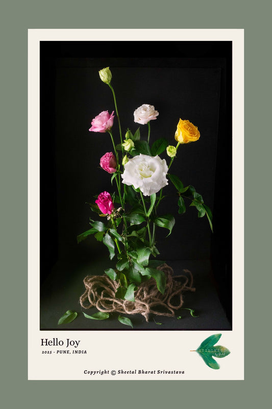 Photograph of Floral arrangement with pink, white, and yellow Lisianthus flowers on a dark background.