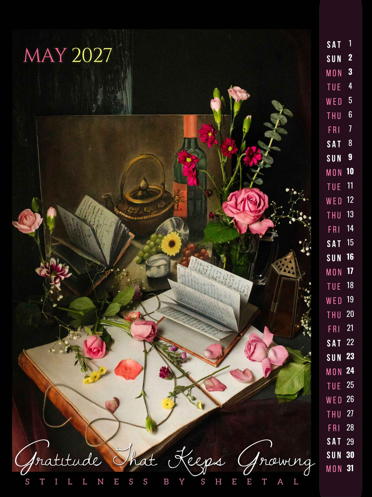 May calendar page, "Gratitude That Keeps Growing" — pink roses and an open handwritten journal beside a vintage painting, wine bottle, and lantern, fine art still life photograph by Stillness by Sheetal